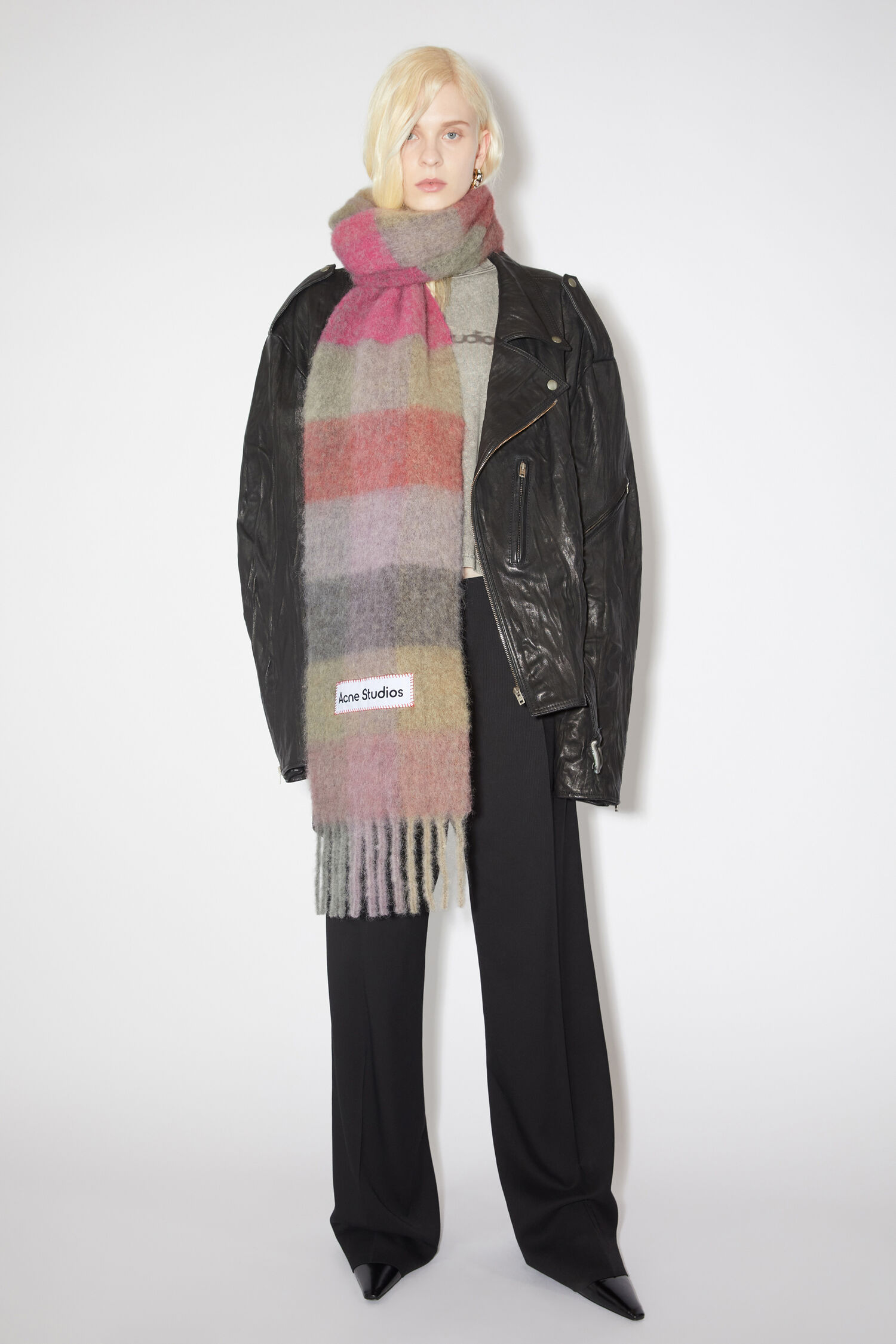 A model wearing an Acne Studio sustainable scarf. 