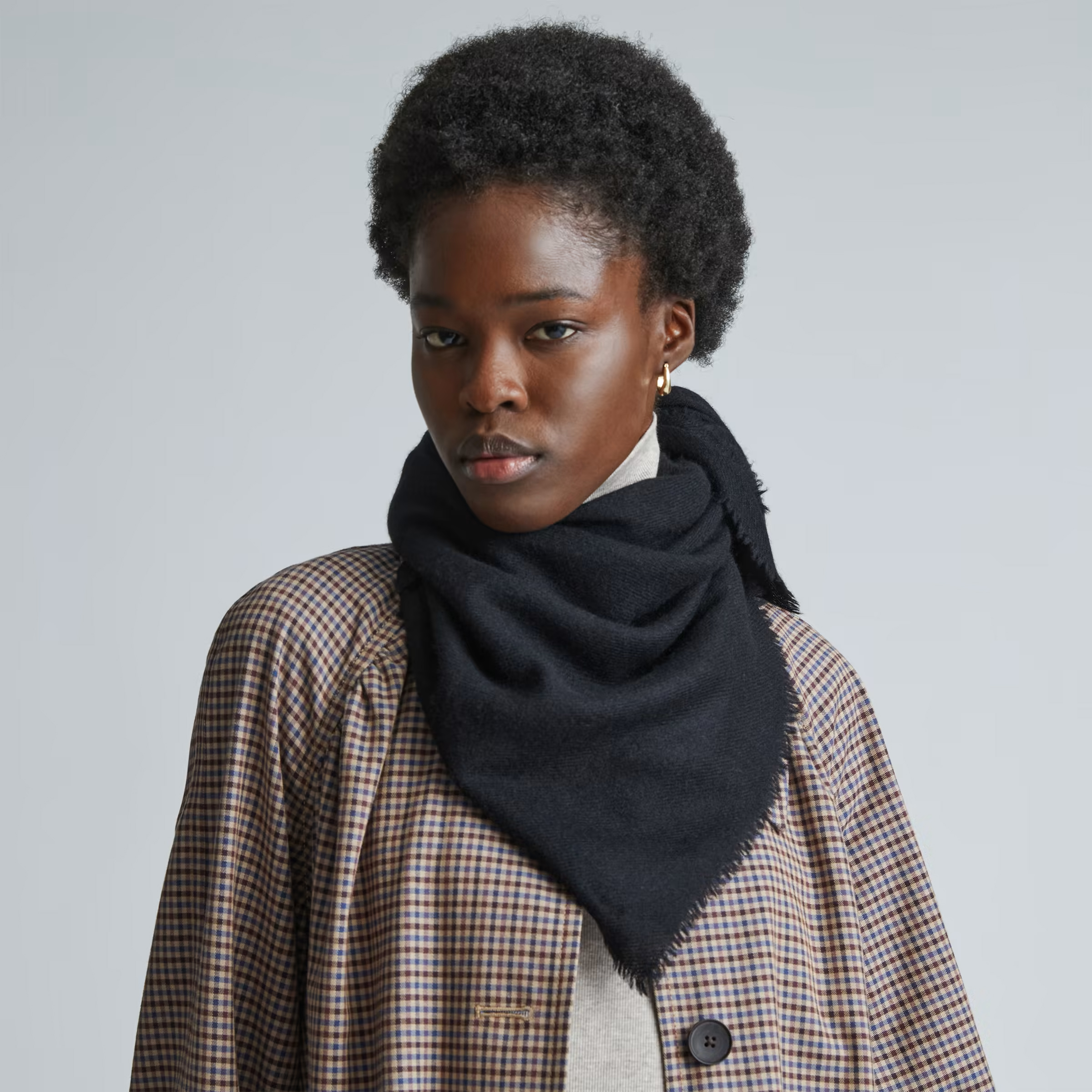 A model wearing an Everlane sustainable scarf.