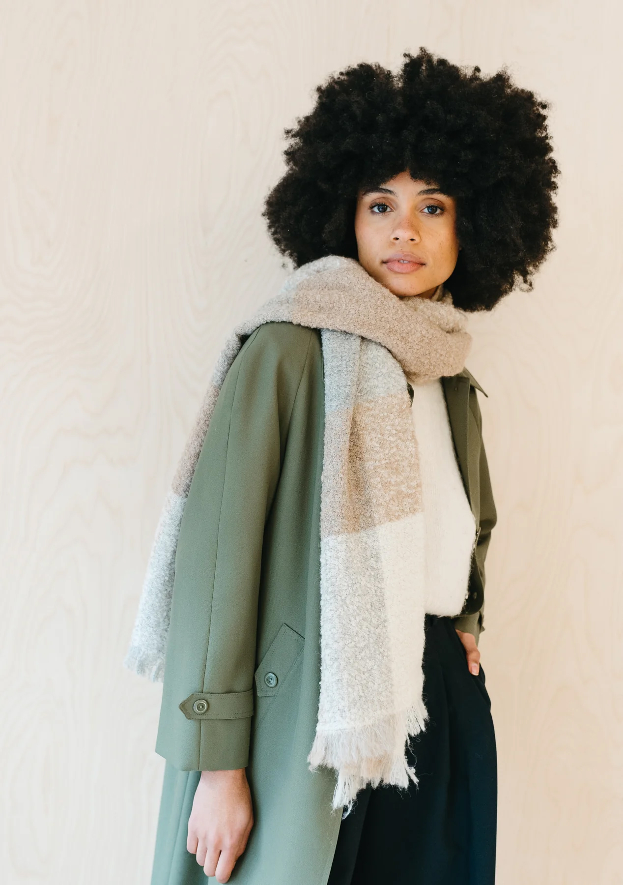 A model wearing a Tartan Blanket Co sustainable scarf.