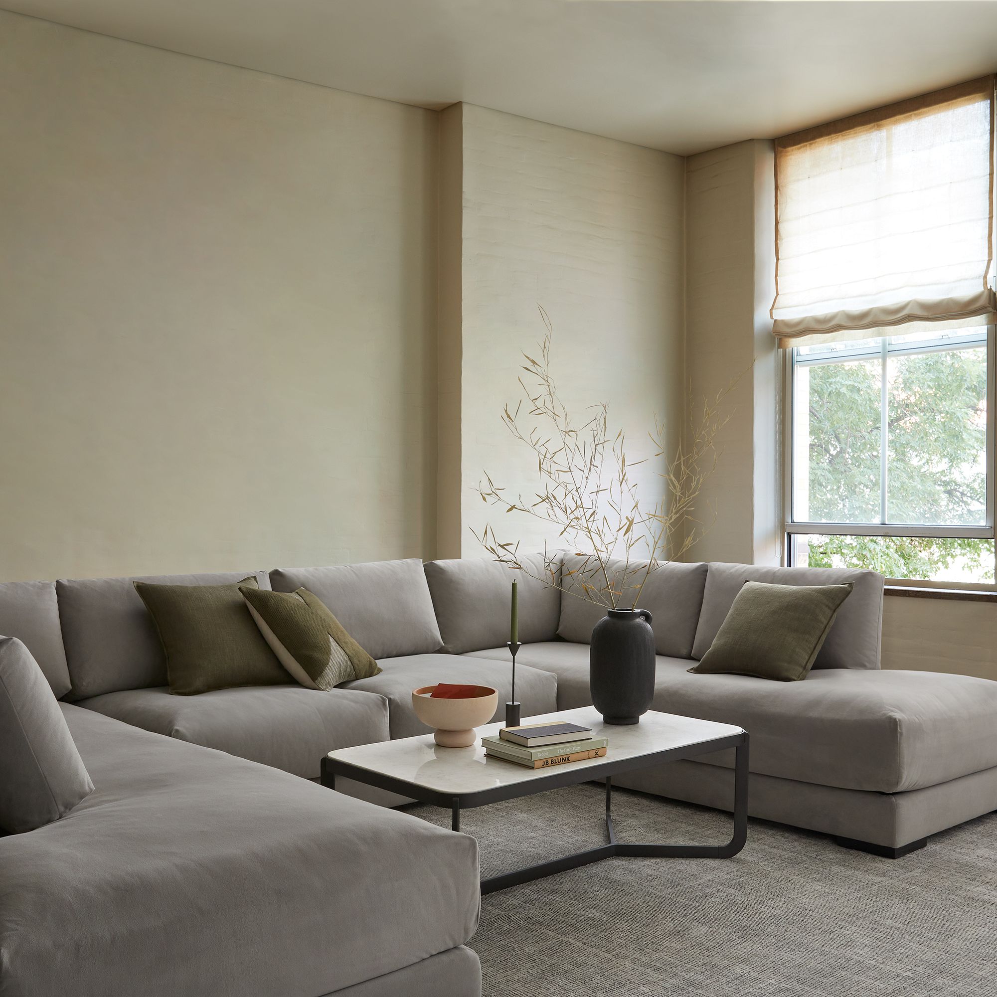 A gray sectional couch in a styled interior.