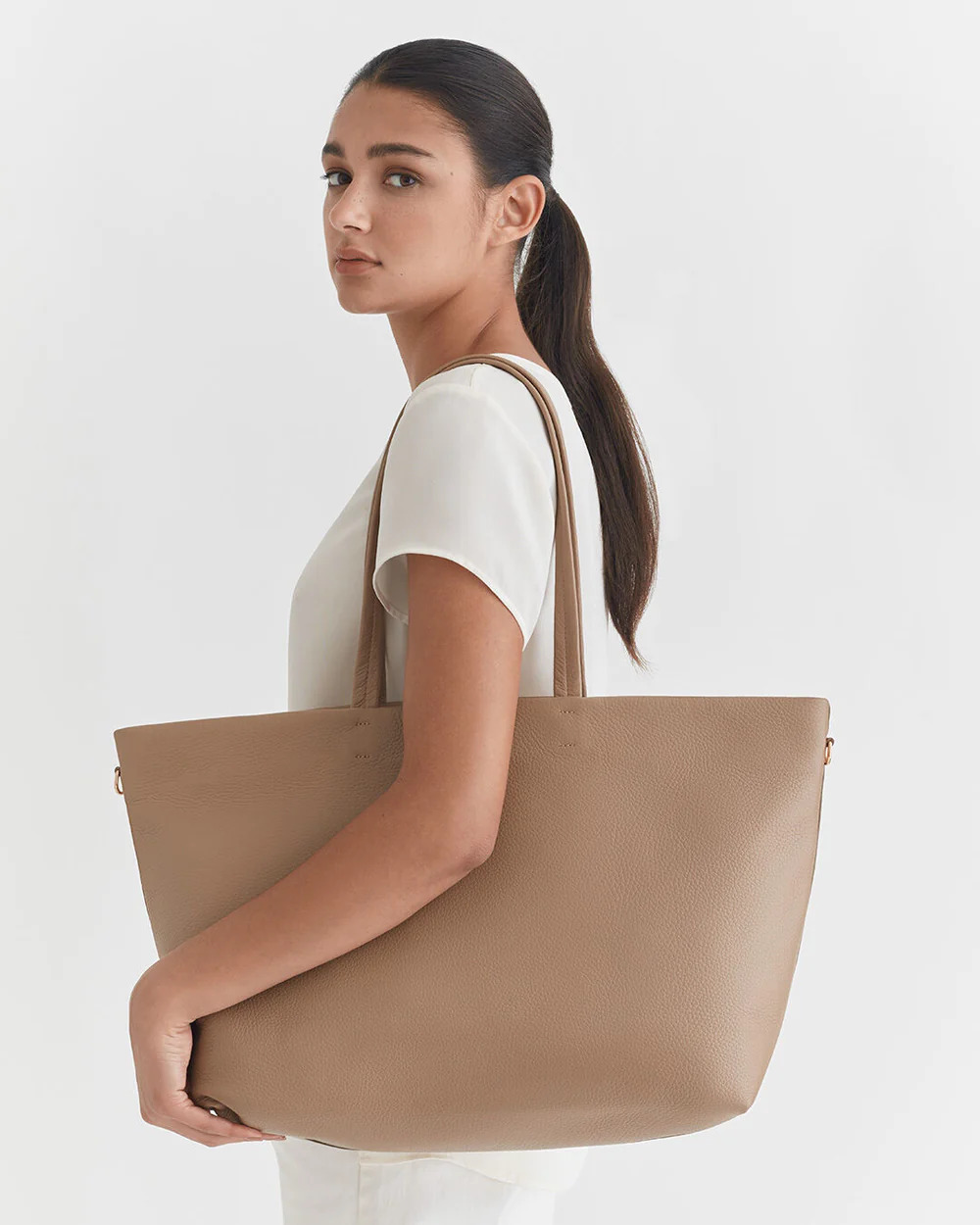 Model wearing a Cuyana Customizable Bag