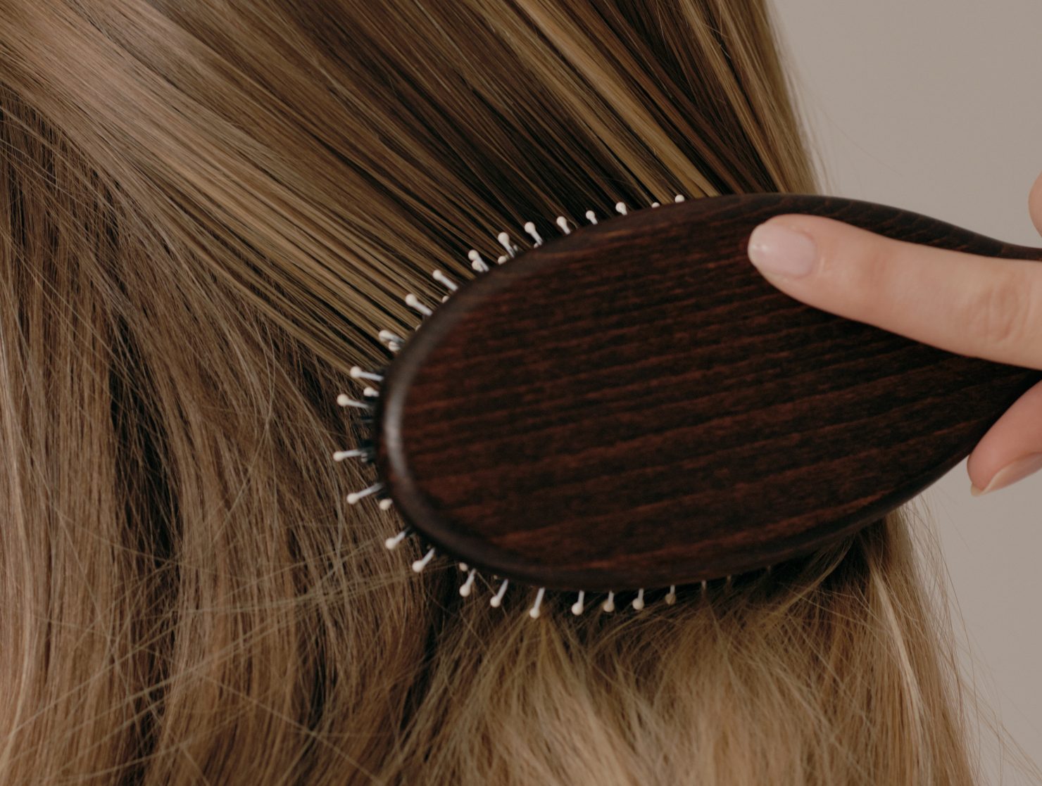 A model using a Prose Monogrammed Hair Brush on her hair