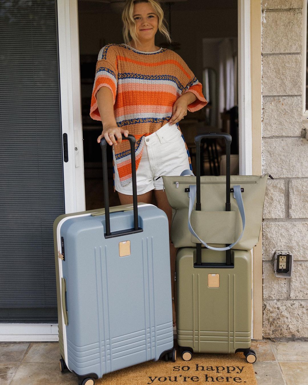 A model with ROAM Customizable Luggage