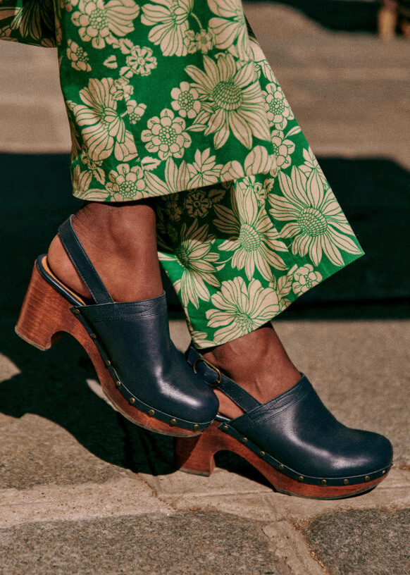 A model in Sezane sustainable clogs.