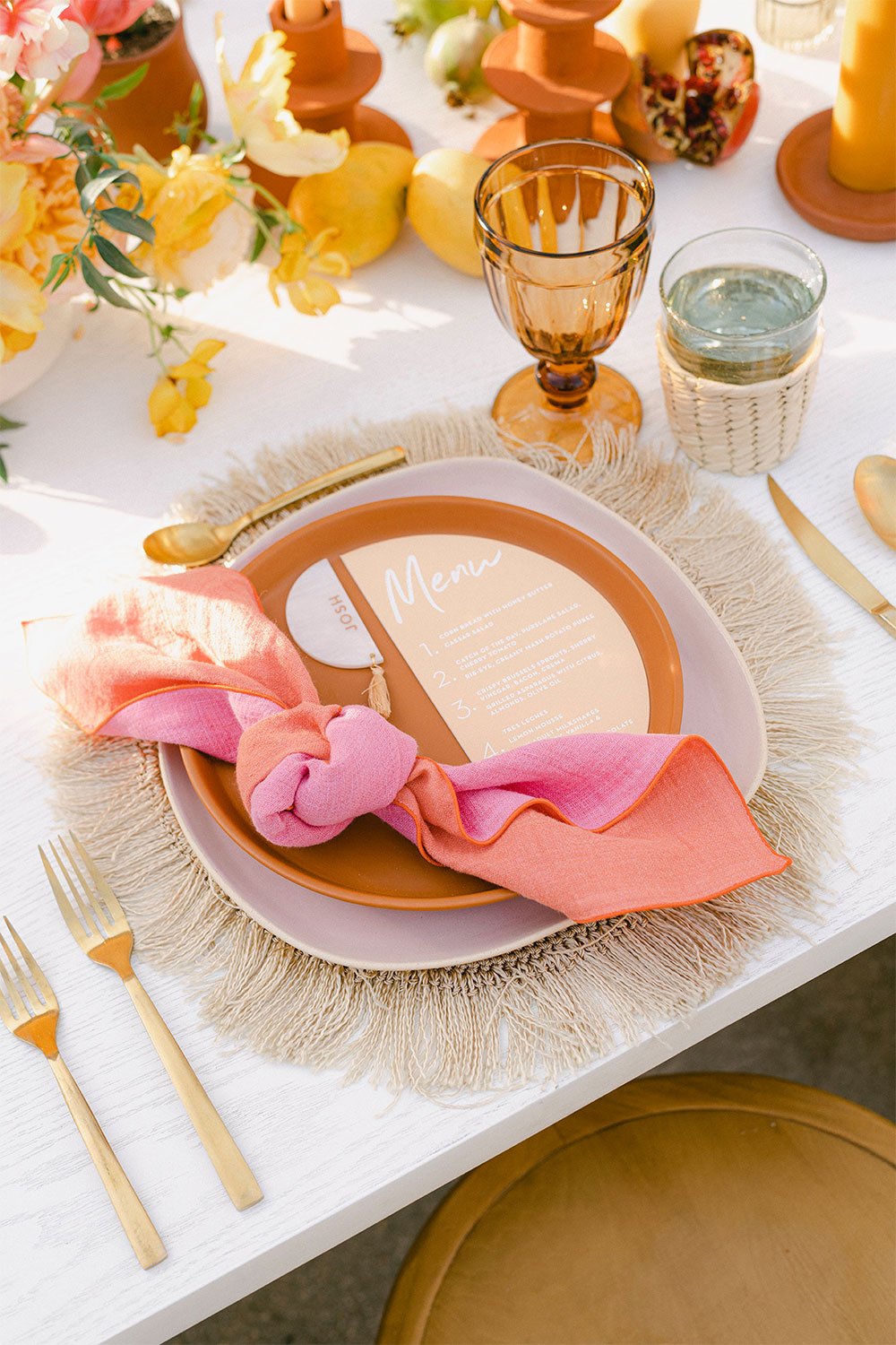 Cloth Napkins: Atelier Saucier's coral and pink linen napkins are tied into a table setting and placed on top of a menu and formal dinner table.