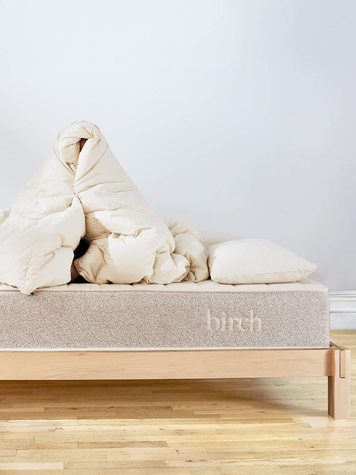 Birch undyed organic comforters on a bed.