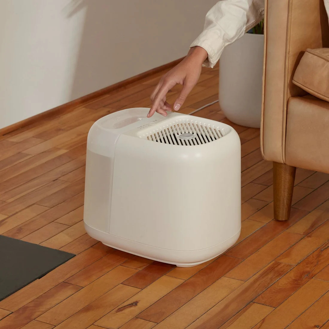 A hand turning on a Canopy Humidifier