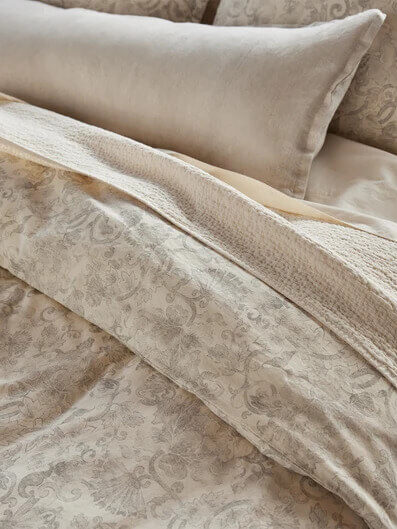 Grey and white pale floral Coyuchi sheets set.