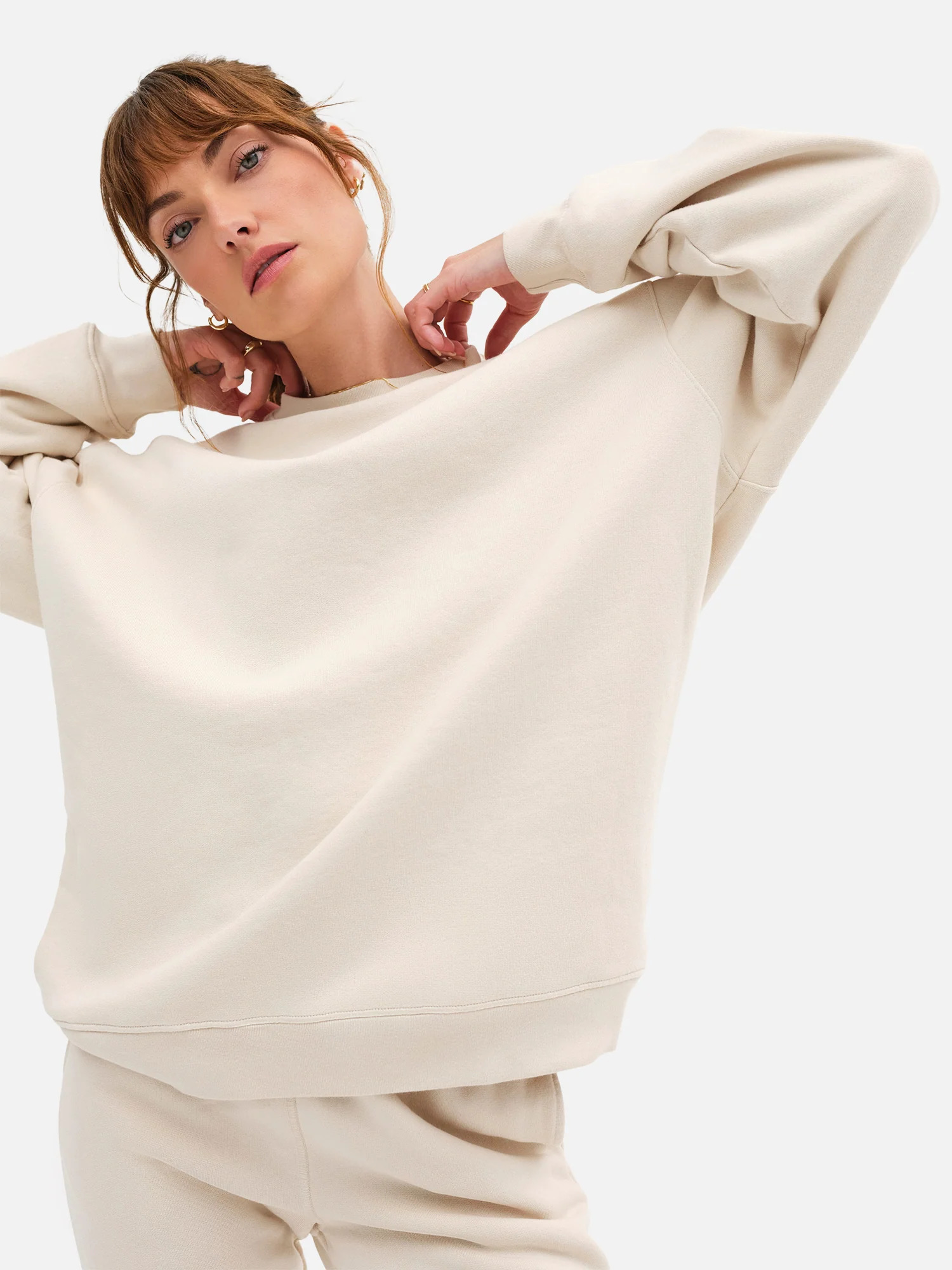 A model wearing a white MATE The Label Sweat Set.