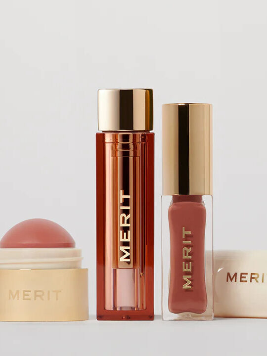 Merit makeup products lined up next to each other in front of a white background.
