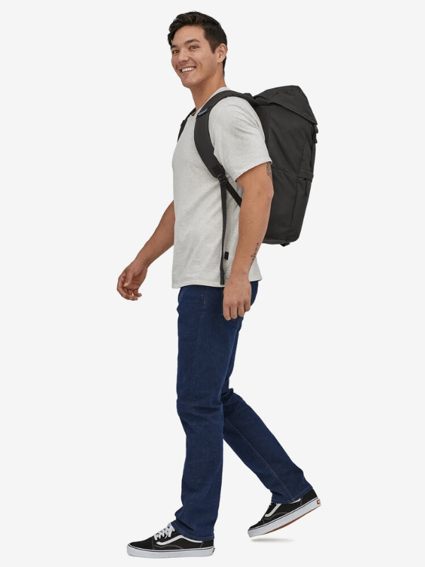 A model walks by with a backpack on.