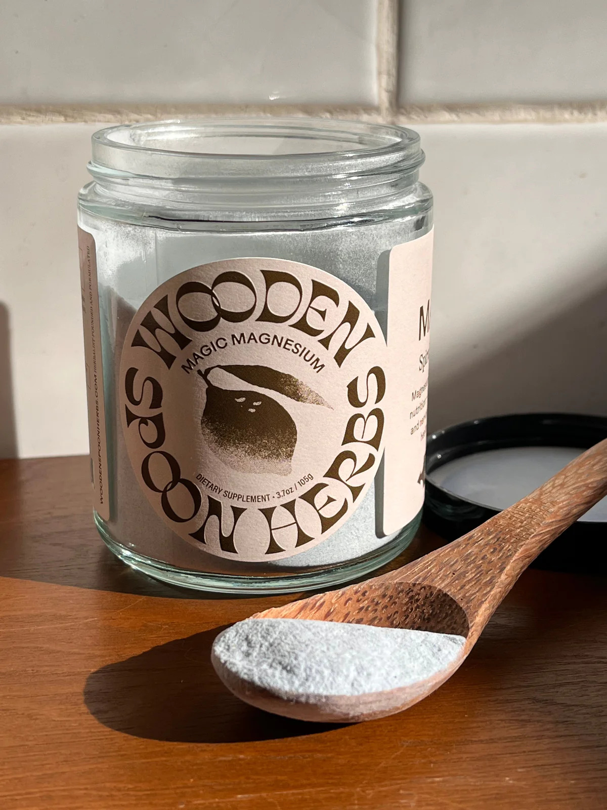 Wooden Spoon Herbs jar next to a spoon with powder in it