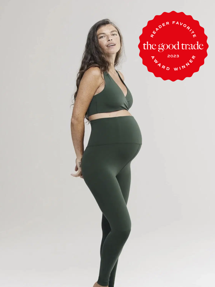 Model wearing a green sports bran and matching maternity leggings