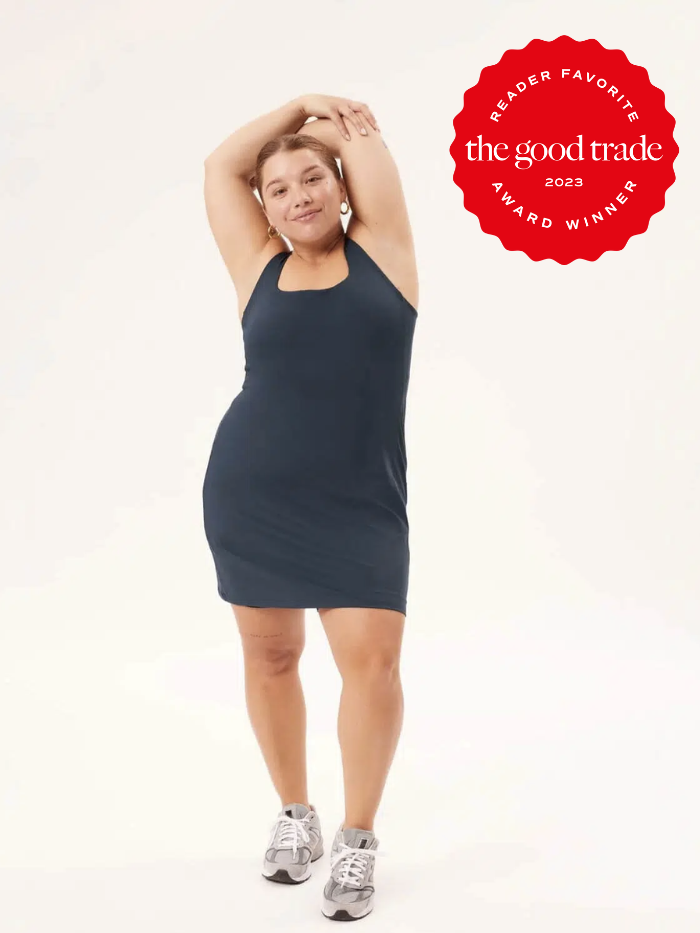 A plus size model in an activewear dress with the TGT reader award badge for 2023.