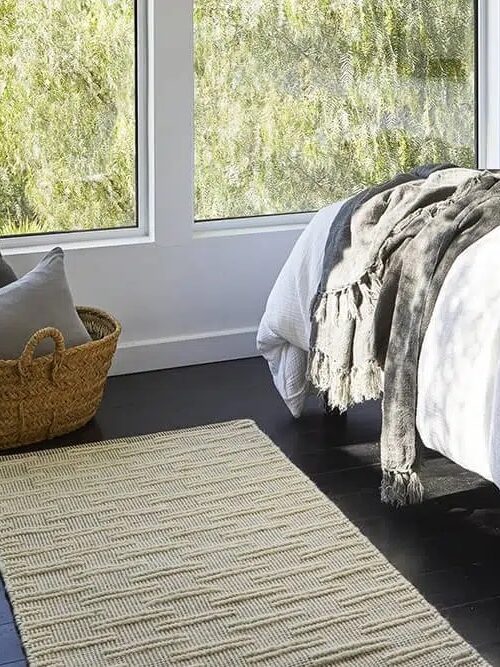 A nontoxic Parachute rug in a styled bedroom.