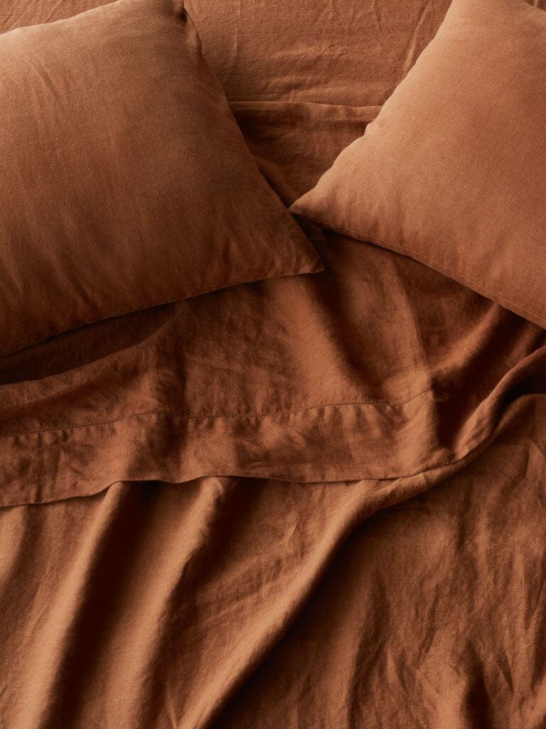 Terracotta-colored linen sheets.