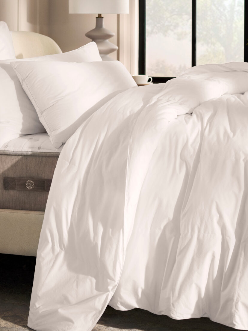 A white Boll + Brand organic comforters on a bed.