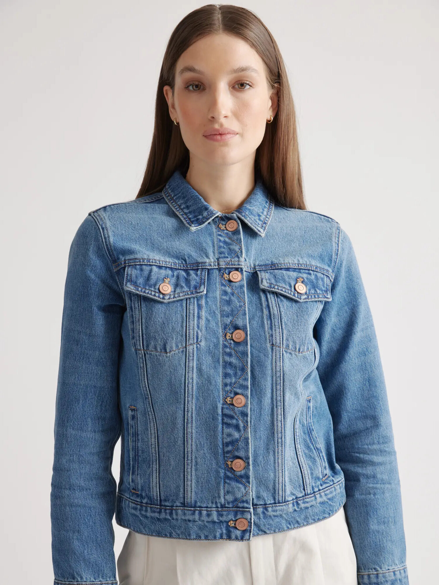 Model wearing a Quince Organic Cotton Denim Jacket buttoned up