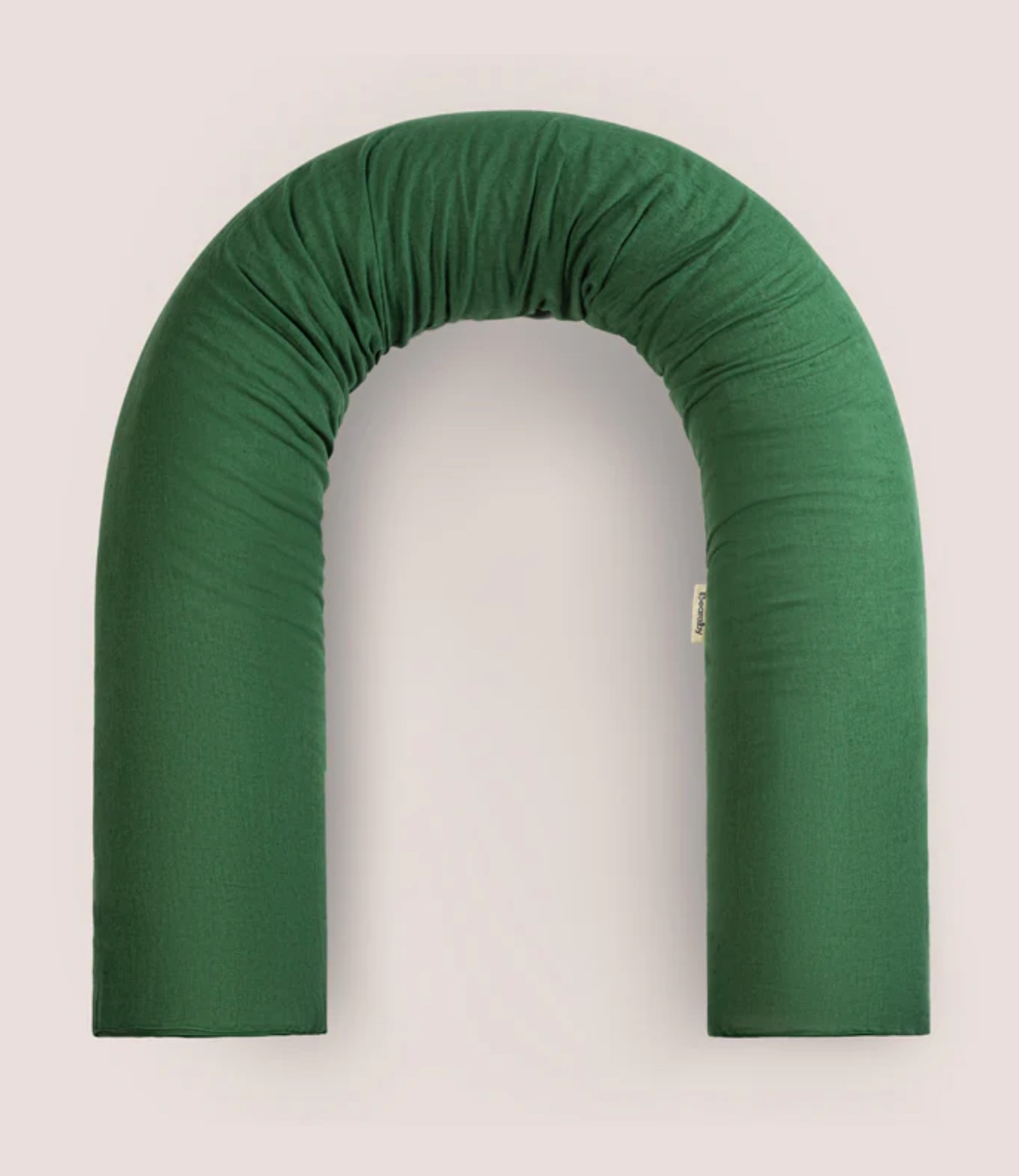 The Bearaby pillow in a green cover.