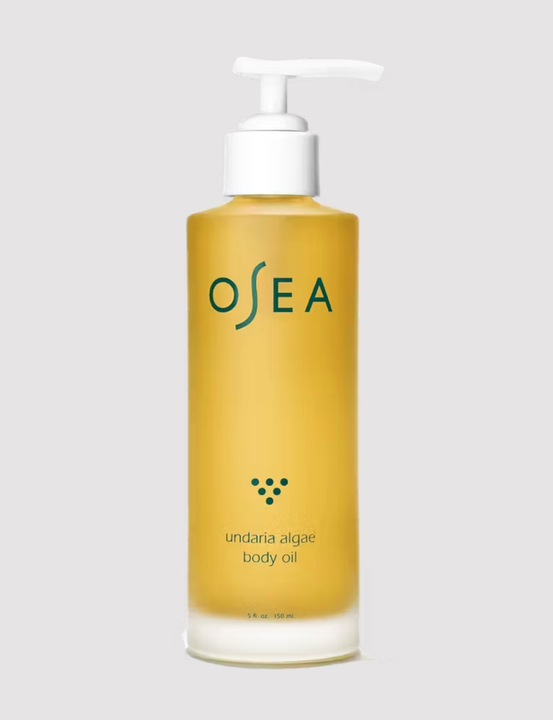 A bottle of the OSEA body oil in a gray studio shot.