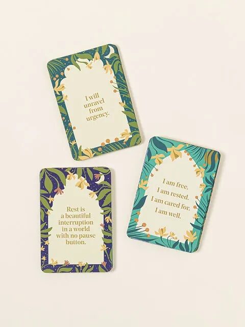 Three cards face up with gold text and floral graphics