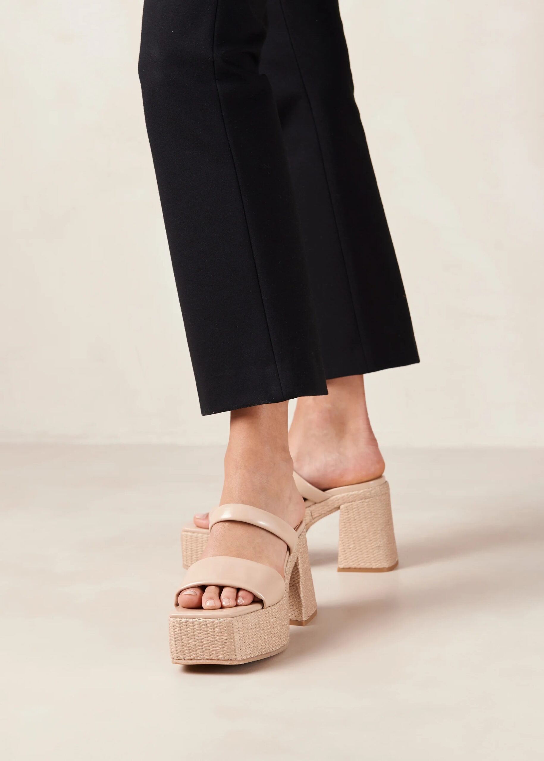 Alohas vegan leather platform sandals on a pair of feet in a studio shoot.