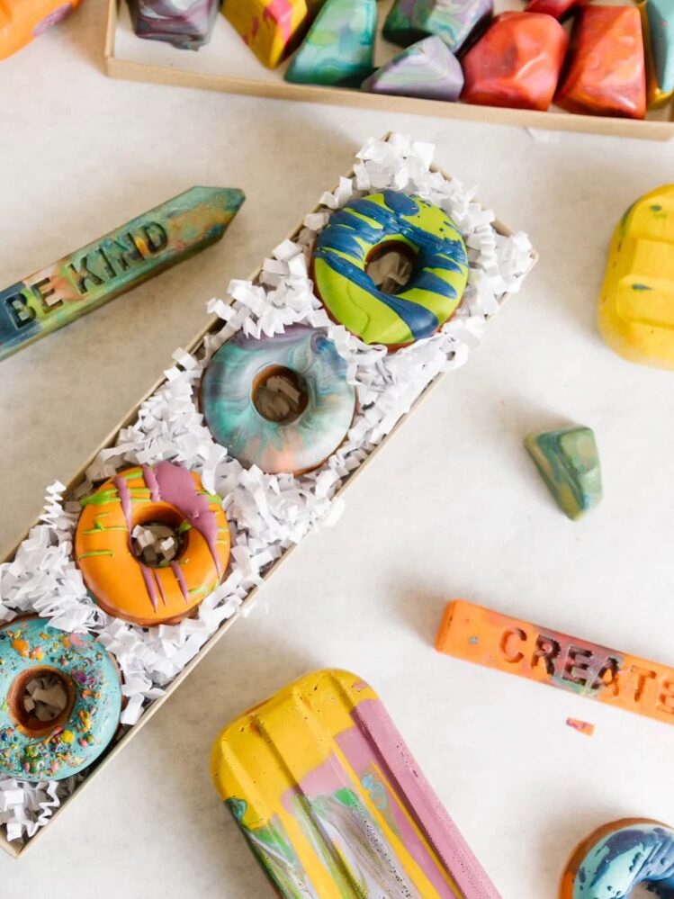 Handmade crayons in the shapes of pencils, donuts, and rocks