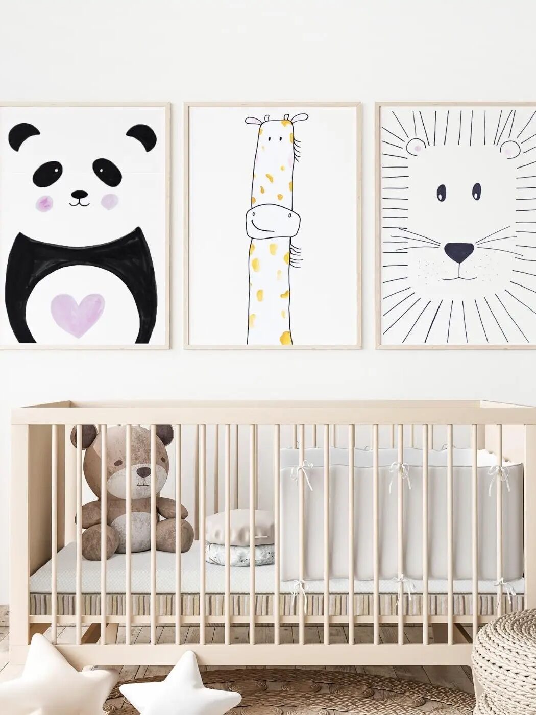 The Essentia Crib Mattress in a crib frame with toys and framed animal illustrations above it.