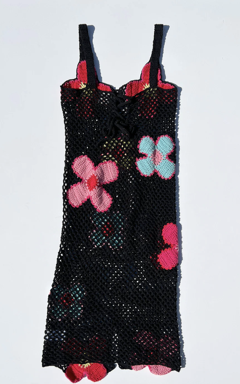 A black crochet dress with blue, pink, and red flowers