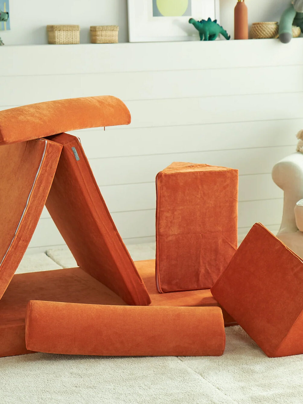A pile of orange play couch cushions