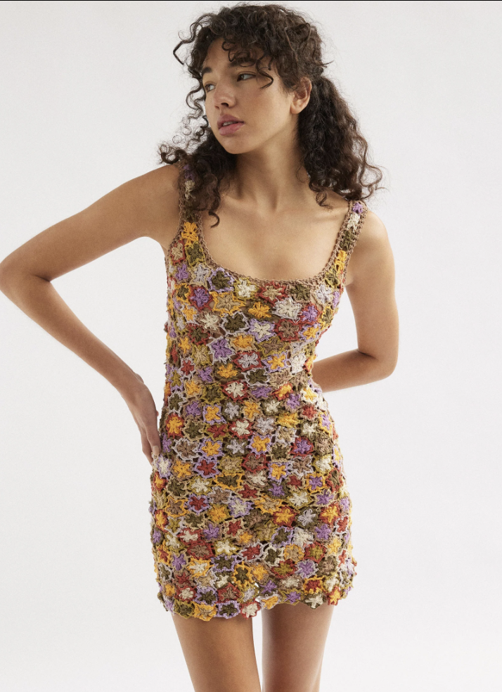 A model in a floral mini crochet dress