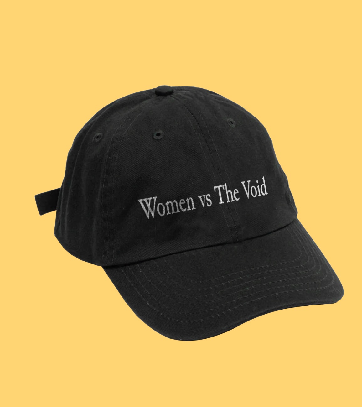 A black baseball hat that says "Women vs The Void"
