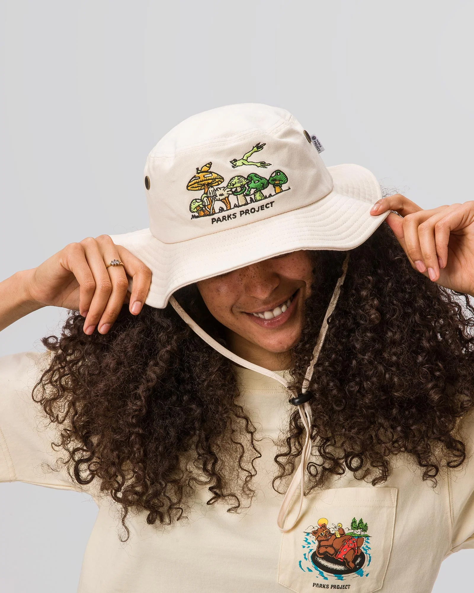 A cream bucket hat with logo