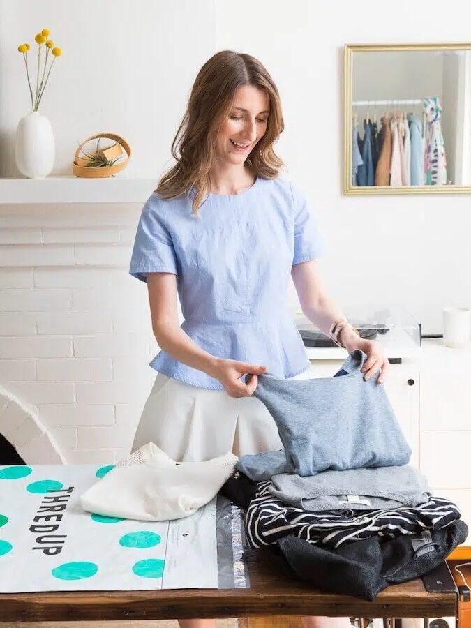 A woman packs up her ThredUp bag