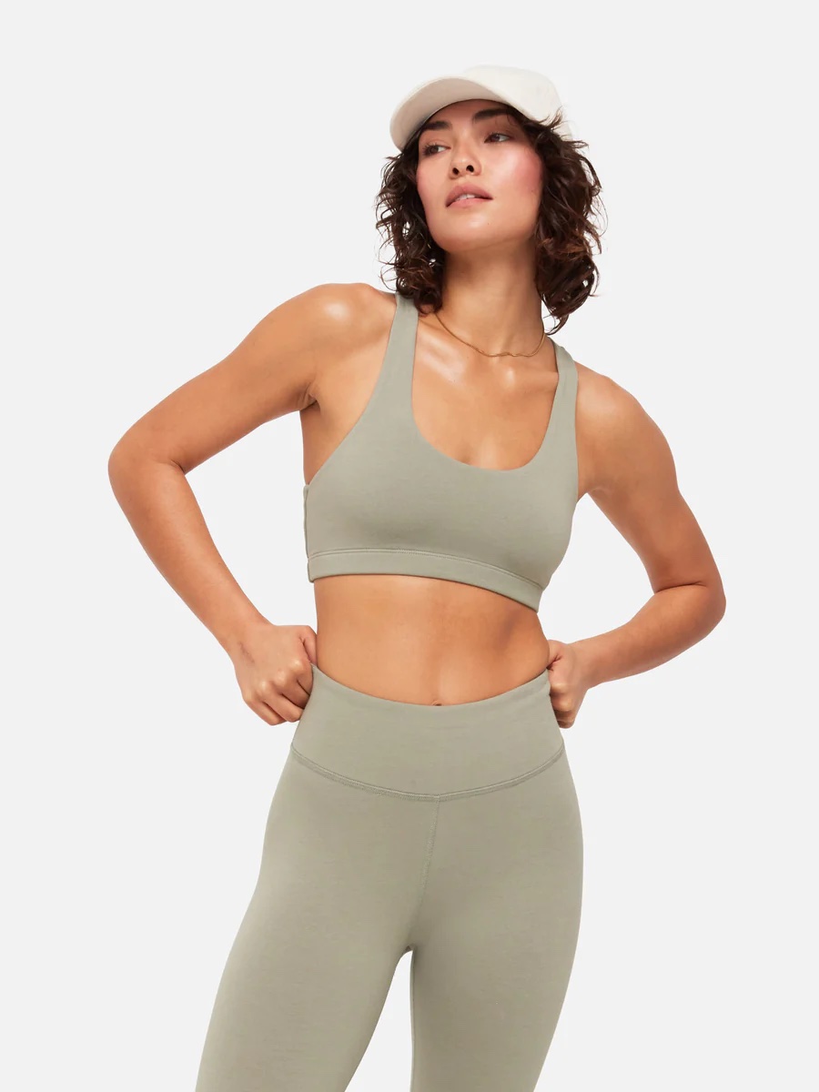A model in a sage green workout set.