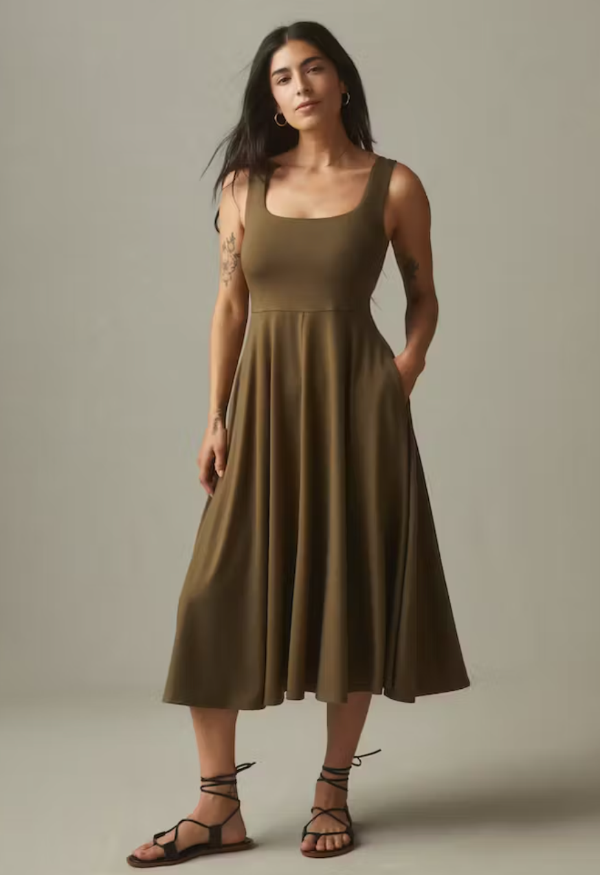 A model in an olive green dress.