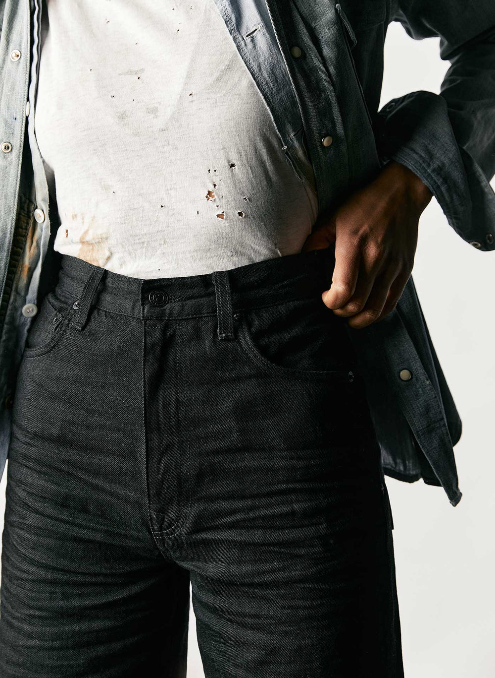 A closeup of extra high rise black American-made jeans.