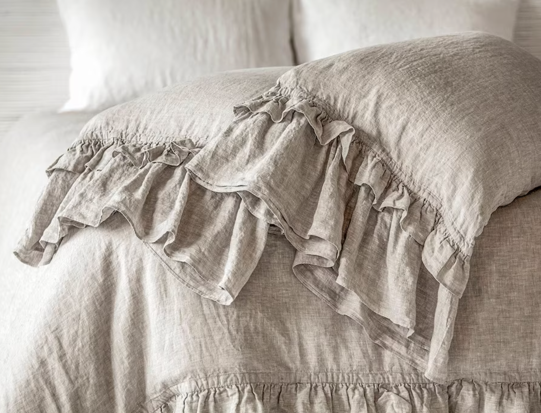 A ruffled linen pillowcase in flax.