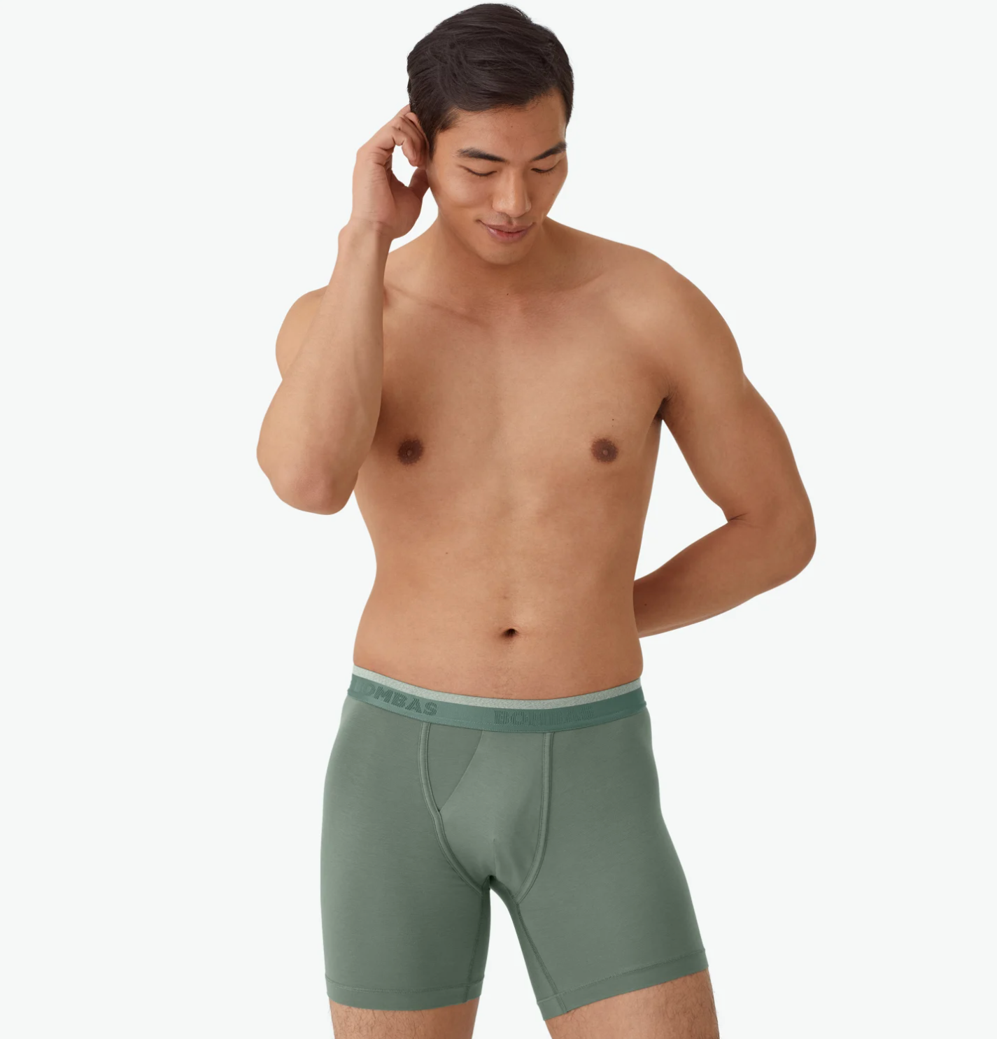 A model wearing green boxer briefs.