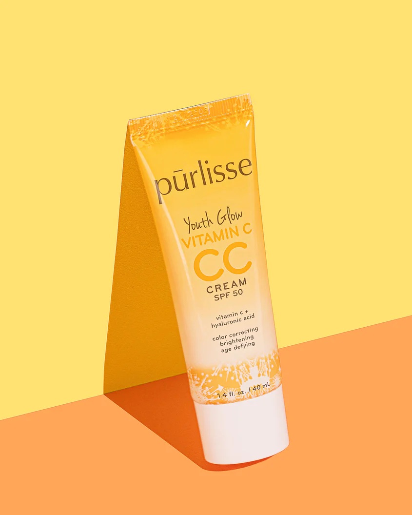 A tube of CC cream against a yellow wall.