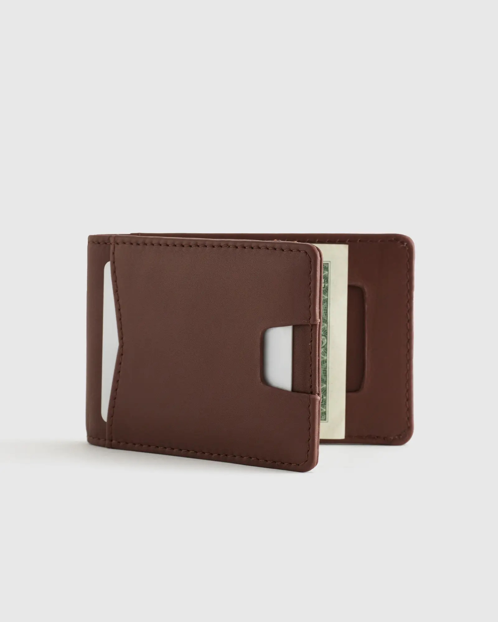 An open brown leather slim wallet.
