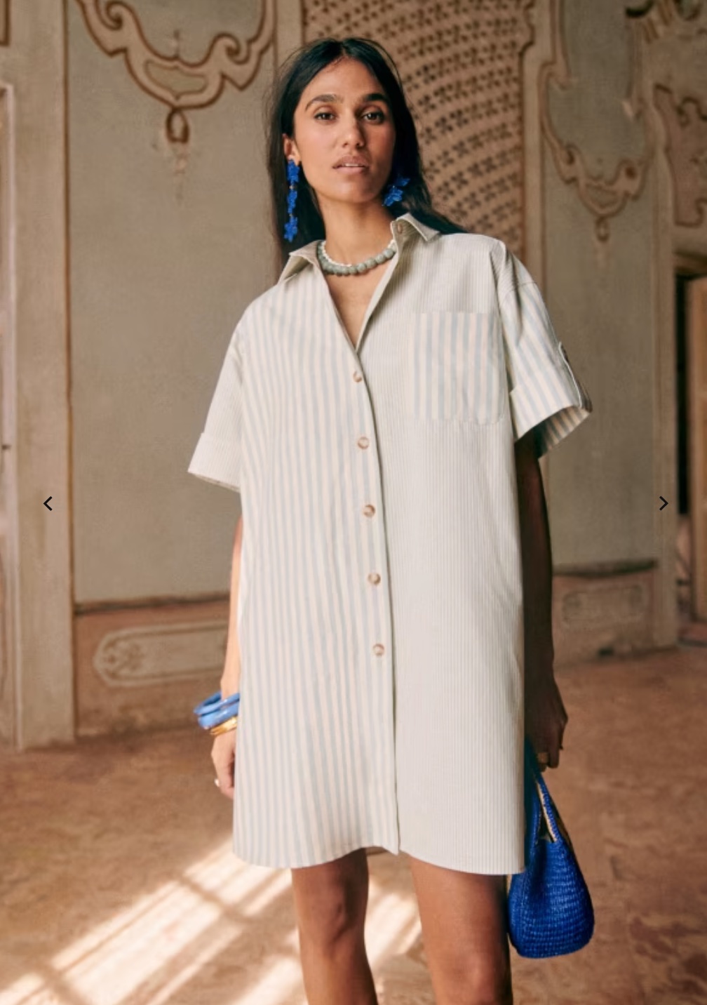 A model in a striped mini shirt dress