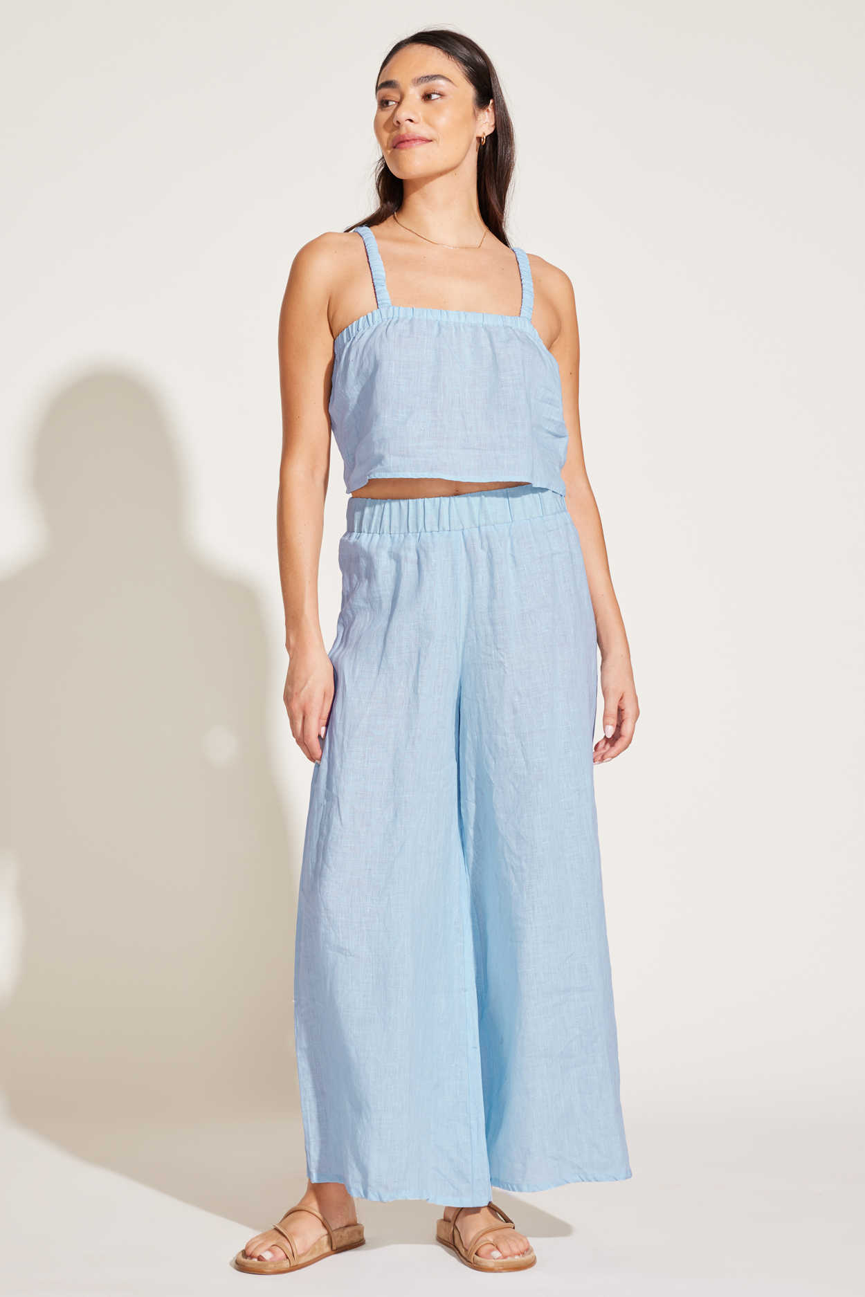 A model in a baby blue tank and wide leg pants set.