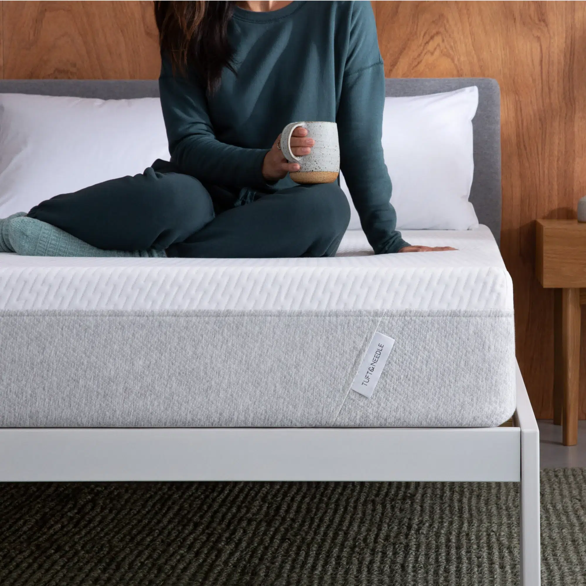 A model sits on an eco-friendly foam mattress. 