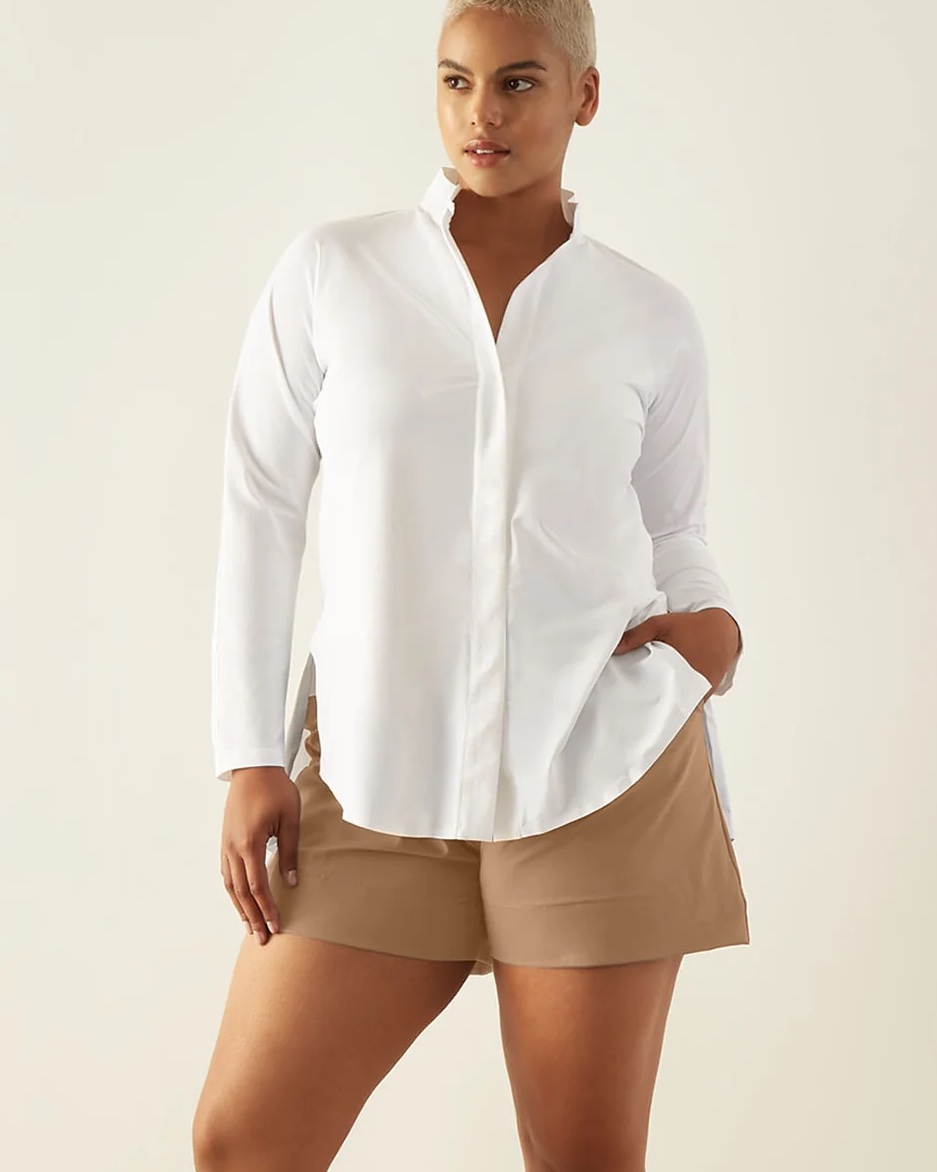 model in white button down and light brown shorts