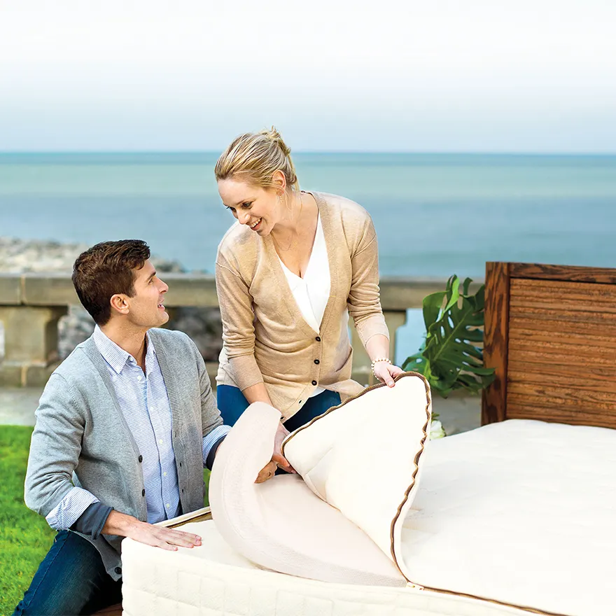 A couple peels back the layers of their vegan mattress by the ocean. 