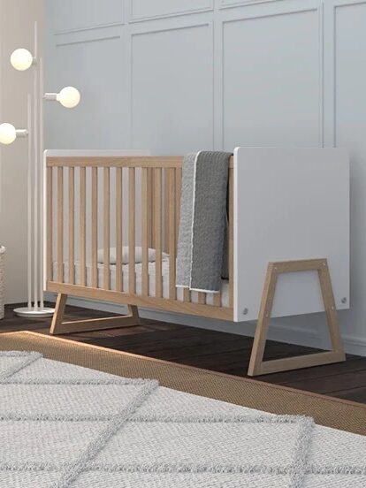 A white and natural wooden crib.
