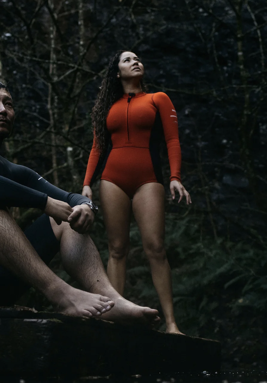 A model in a red long sleeved one piece.
