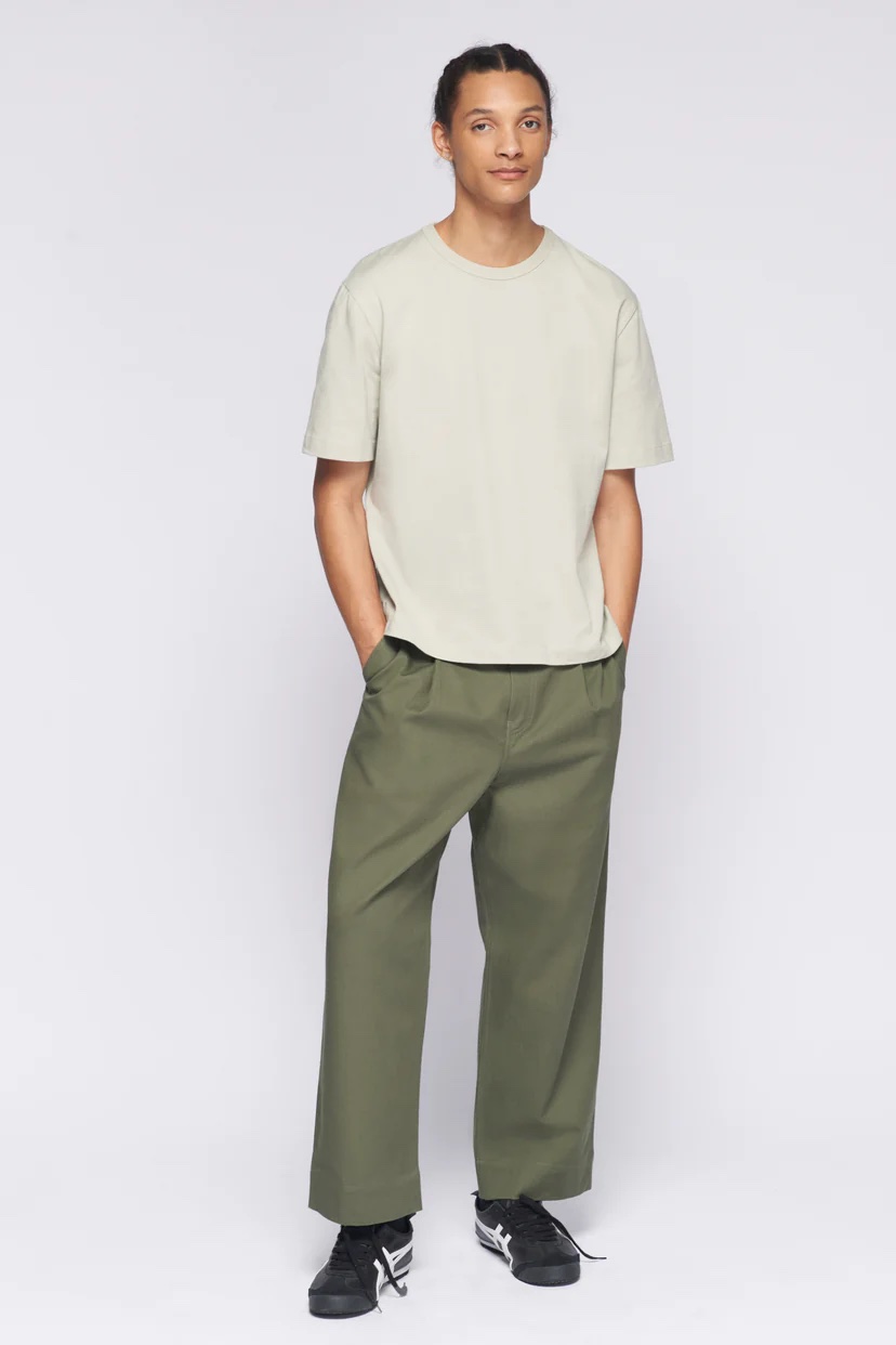 A model wearing a taupe tee and olive pants.