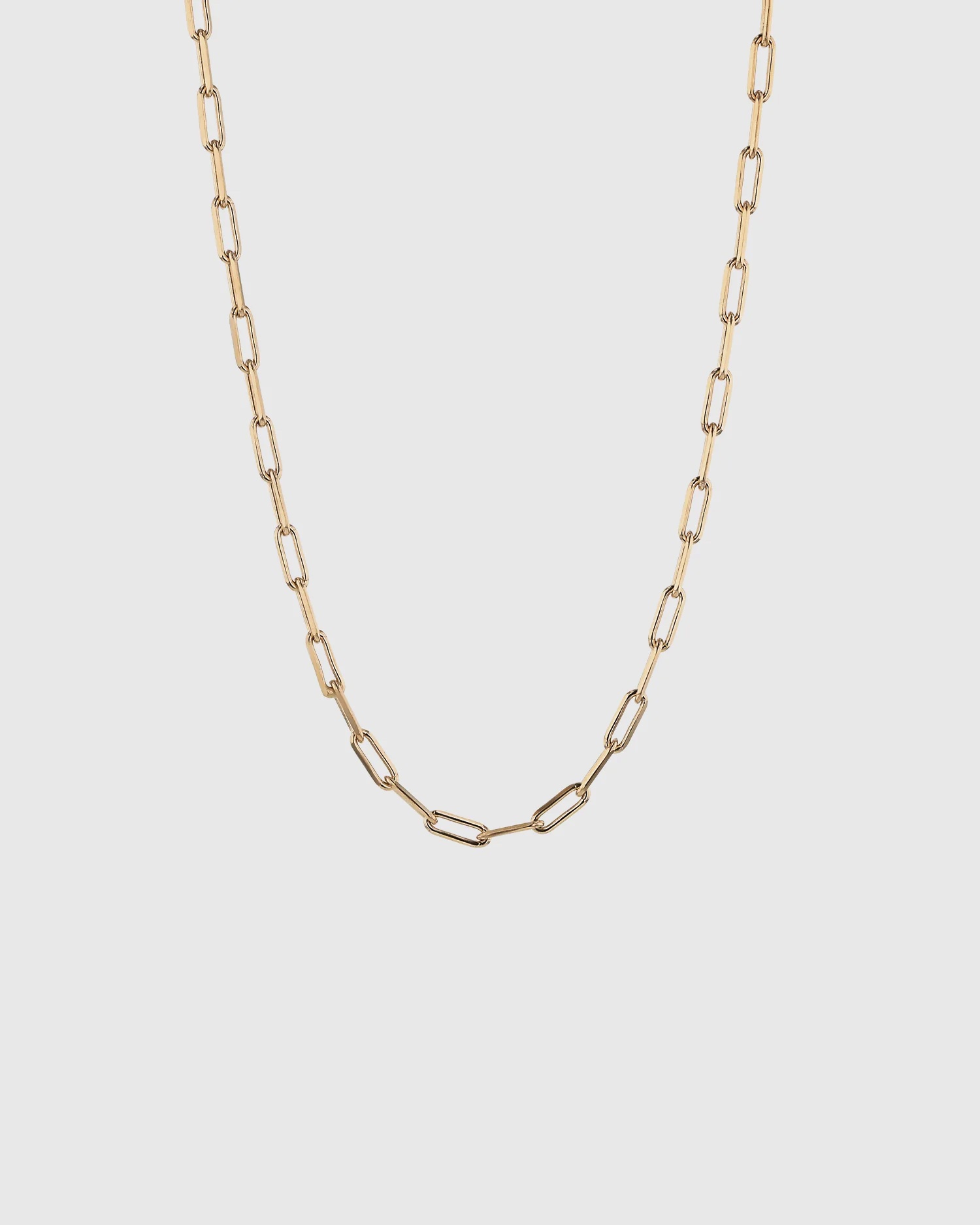 A gold block chain necklace. 